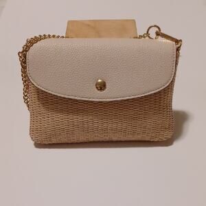 Tan Straw Mini Hand Bag With Beige Faux Leather and Goldtone Chain Strap.